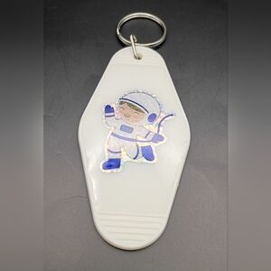 Vintage Style Astronaut Motel Keychain with White and Blue Design